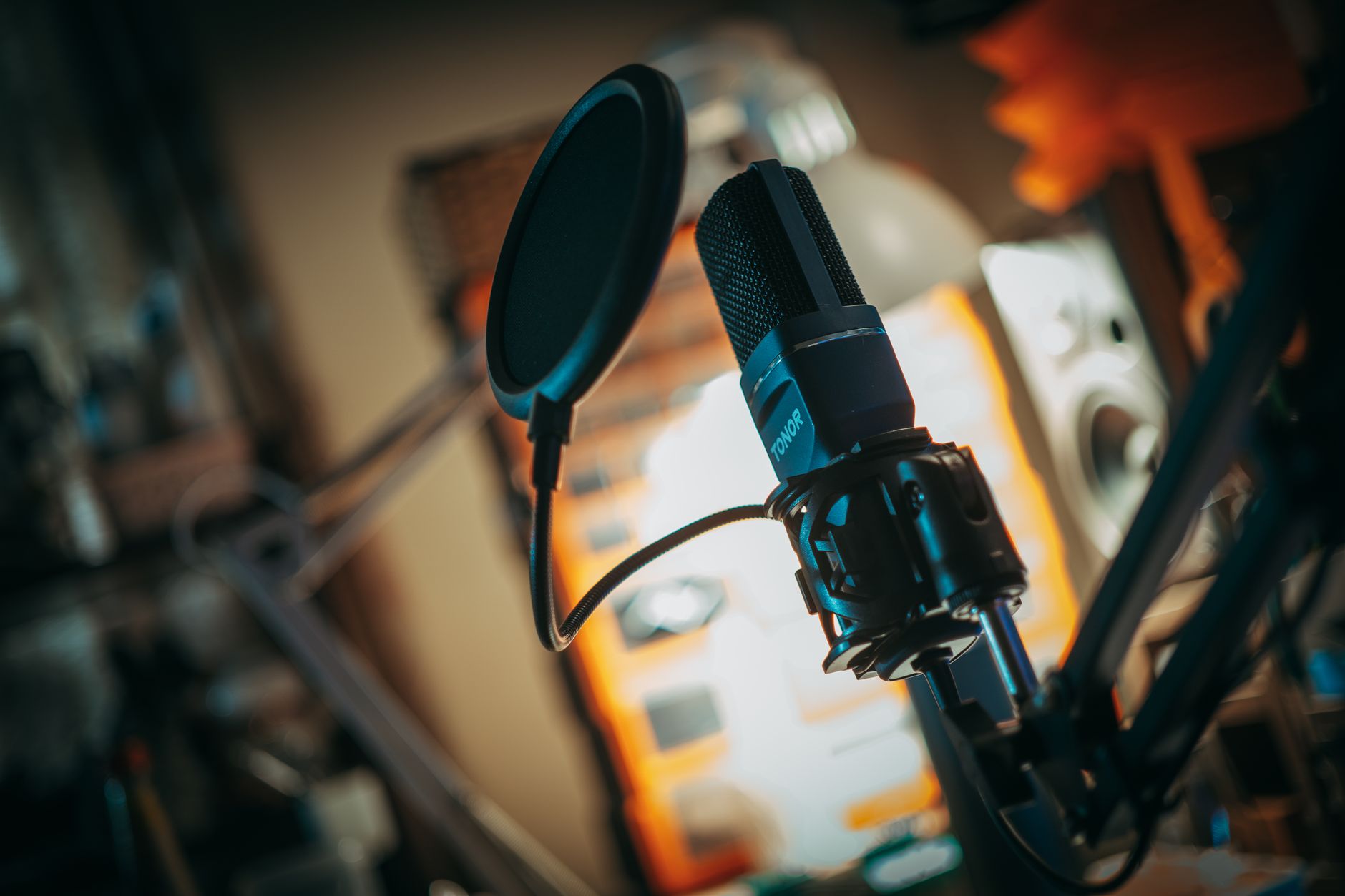 A close view of a studio microphone and pop filter
